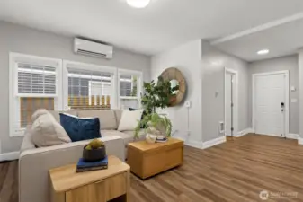 Another view of the living room to the 1/2 bath/laundry and garage entry door.
