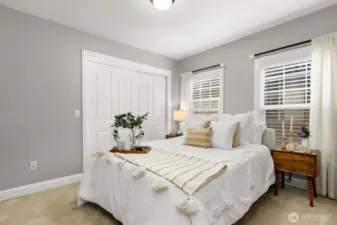Guest bedroom is bright, comfortable and has a large closet.