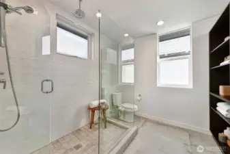 Spa-like primary bath includes heated floors, rain shower and bidet.