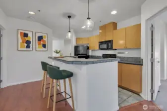 Virtually Staged kitchen with bar eating space.