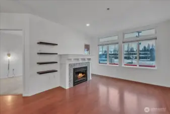 Tall ceilings grace the home, living room with electric fireplace and and door out to the 2nd deck!