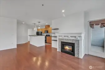 Tall ceilings grace the home, living room with electric fireplace and and door out to the 2nd deck!