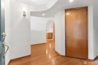 The front entry gives a quick hint that this house has personality. Hardwood floors run down the hallway toward the kitchen, and the arched doorway pulls you forward like the house is casually saying, keep going, there’s more. An arched ceiling detail adds a nice bit of character overhead, and the coat closet is right where it should be for real life, shoes, coats, backpacks, all handled before you even get settled in. Built in 1995 and cared for by one owner, the space feels elegant, comfortable and familiar the second you walk inside.