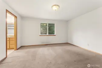 The primary suite sits comfortably on the main floor, part of the easy one story layout that makes daily living feel simple and logical. With 1,663 square feet overall, the home keeps everything within reach, and this room is positioned just right with direct access to its attached bathroom. Neutral white walls make it an easy canvas for any style, and the layout feels intuitive from the moment you walk in.