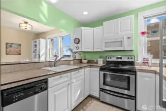 Kitchen looking into dining & living area - partial views of the bay & Stadium HS