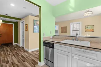 Looking out of kitchen towards unit entrance and living area