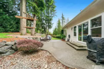 Slider opens from Living room onto patio in fully fenced back yard.