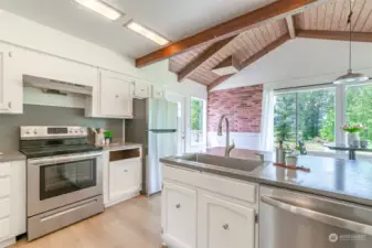 Welcome to the kitchen area w/eating space. The door that is partially hidden behind the fridge leads to a deck with an expansive view of the west side of the property.