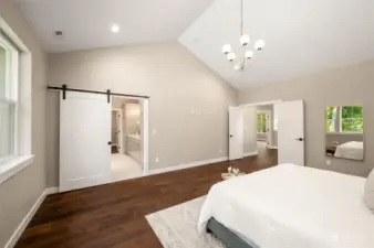 A sliding barn door leads to the spa like bathroom.