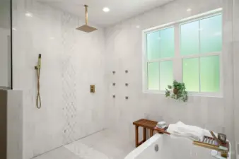 A huge walk in tiled shower with soaking tub.