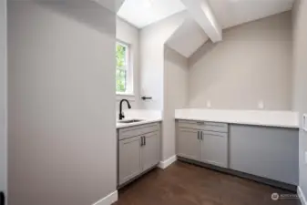 Upstairs laundry room with lots of storage and work space.