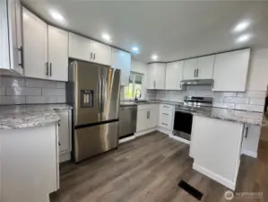 The kitchen has all brand new stainless steel appliances. The quartz countertop, cabinets and all the Luxury Vinyl Plank flooring are also brand new. Plenty of cabinets and countertops make this a chef's dream kitchen.