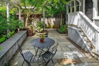 The back patio is well sized for dining al fresco and is enclosed with raised garden beds.