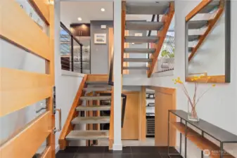 Striking floating staircase anchors the center of the home.