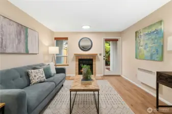Cozy wood burning fireplace with natural light and private fully fenced patio.
