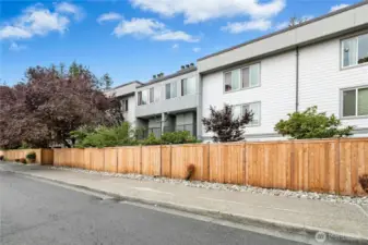 Front exterior of unit with new tall fencing for all ground floor units.