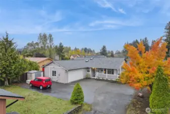 Front drone shows excellent RV parking area next to house.