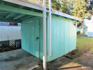 SHED W/ POWER IS BUILT INTO CARPORT.