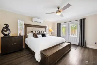 Primary Bedroom: Hardwood Floors, Ceiling Fan, Mini-Split for Heat and AC, French Doors to Pool Patio and  Luxurious En Suite Bath accessed via Pocket Door (not shown, to the right)