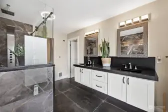 Primary En Suite: Live in Luxury! Heated Black Tile Floors, Granite Counter w/Moen Faucets & Kohler Black Sinks, Mirrored Medicine Cabinets for discreet storage.
