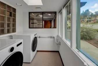 Laundry area off of the kitchen and to the left of the back French doors.