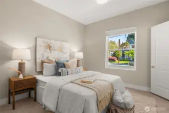 East facing secondary bedroom on the main floor offers abundant natural light.