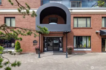 Enter the complex via the parking lot on the backside of the building.