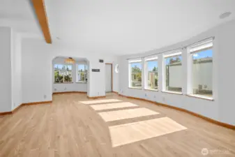 Bright, open living space with vaulted ceilings. View toward entry and breakfast nook.