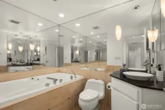 Hall bath features a deep soaking tub with hand held shower.