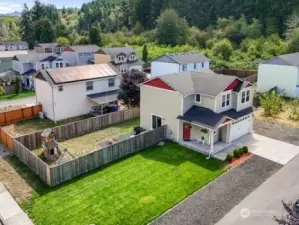 Aerial view of home and lot.  Parking in front, side and next to home.  Large fence area that wraps around back and side of home.