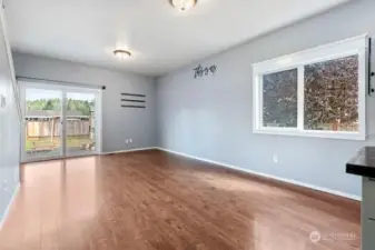 Living area looking toward the slider with access to the back yard.  Large window on the right is a venting window.