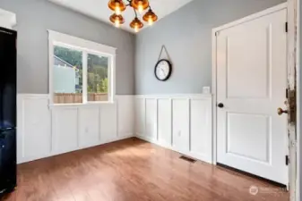 Remodeled dining area walls with wainscoting and new lighting.