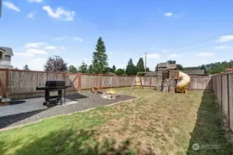 View from back side yard looking into the area off the slider.  Children play equipment will stay with home.  Graveled area off patio.