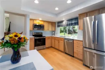 Well-appointed kitchen featuring warm wood cabinetry and sleek modern updates.