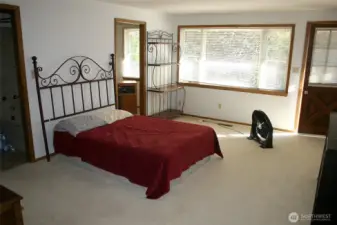 Primary main floor bedroom with access to upper level patio.