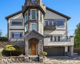 Custom-built home with natural stone finishes, three balconies facing the Sound, and quality construction throughout.