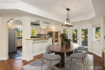 Inviting formal dining area, opening to kitchen and entertaining patio. Virtually staged.