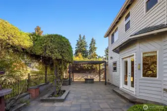 Natural stone patio off dining room/kitchen, with planters and lovely treed views.