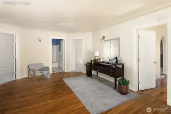 At the top of the grand stairwell, a spacious atrium connecting all 4 bedrooms, and the laundry area. Virtually staged.