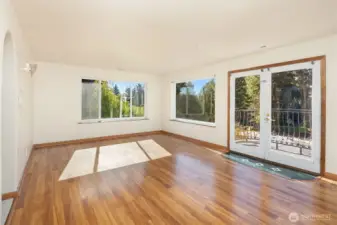 Generously-sized primary bedroom with French doors to Juliet balcony.