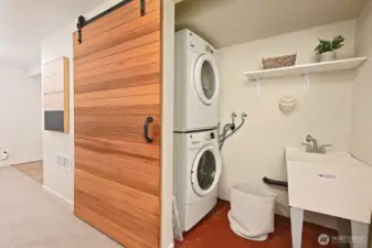 Full size washer and dryer with laundry sink.