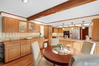 Eating nook off kitchen with beamed ceiling