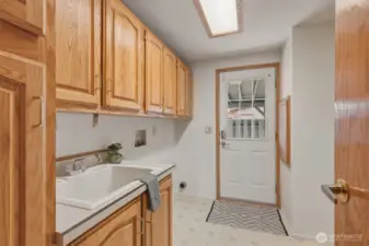 Utility room with sink and plenty of storage.