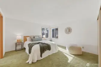 Primary bedroom is light and bright with ample closets.