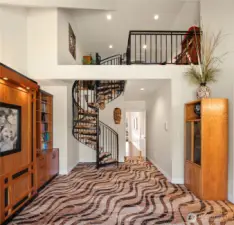 This versatile bedroom features custom shelving with a built-in Murphy bed and an elevated loft retreat.