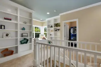 The upstairs landing has a window seat with views over the pool and cabana, and the sunrise lights up the hallway in the mornings.  The laundry room has cabinets, a folding counter, and a laundry deep sink.