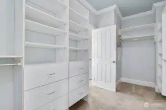 Walk-in closet connects to the bedroom through this door, and to the bath through another door.