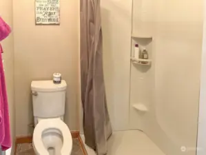 Primary walk in shower with hand rails