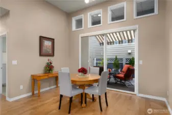 Spacious dining area with the sliding glass door leading to the super private outdoor space.
