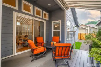 Oversized sliding glass doors open up to a beautiful composite deck and a motorized awning. This side of the home gets delightful SW exposure.